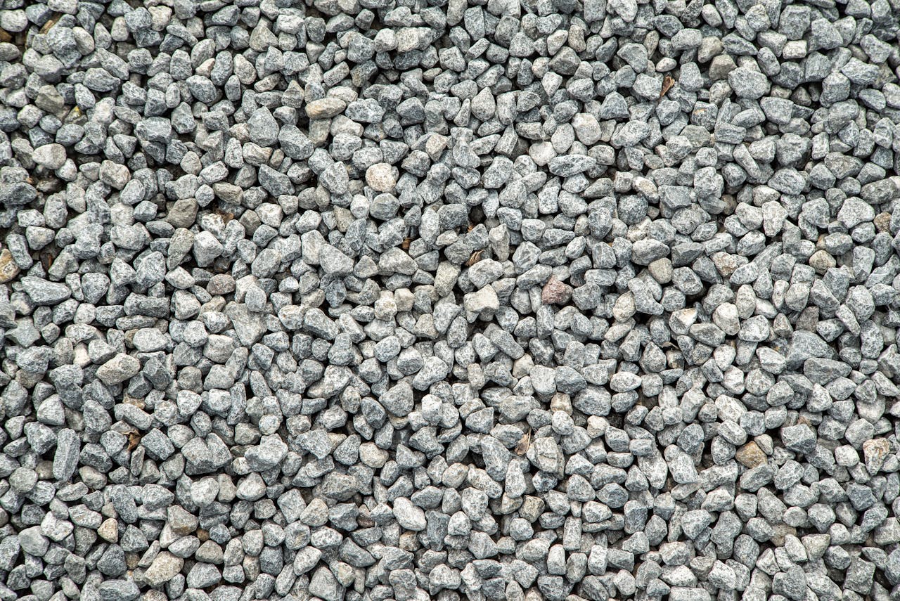journey-02 Detailed view of grey gravel stones creating a textured pattern for background use.